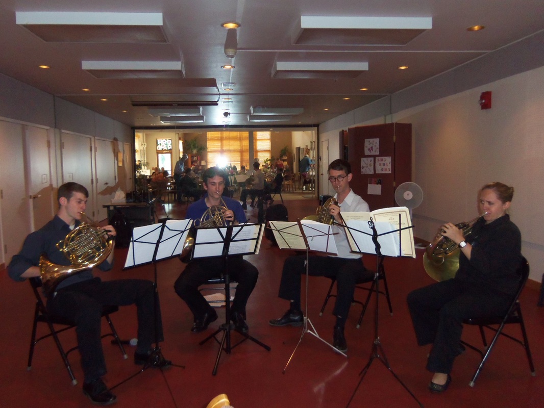 music festival students playing french horns indoors